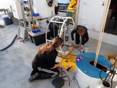 Technicians prepare the conductivity, temperature and depth (CTD) probe as part of the suite of physical oceanographic data collected